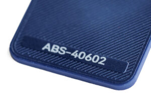 ABS 40602 - KIT3D GmbH – 3D-Technologie & Konstruktion Close-up of blue textured plastic surface with a raised label reading ABS-40602