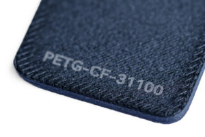 PETG CF 31100 - KIT3D GmbH – 3D-Technologie & Konstruktion Close-up of a dark blue textured material edge with the label PETG-CF-31100 stamped on it