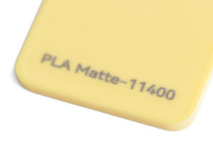 PLA Matte 11400 - KIT3D GmbH – 3D-Technologie & Konstruktion Close-up of a yellow plastic item with the stamped text 'PLA Matte-11400'.