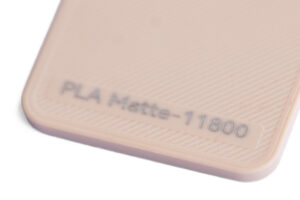 PLA Matte 11800 - KIT3D GmbH – 3D-Technologie & Konstruktion Close-up of a beige textured surface with a label reading 'PLA Matte-11800'.