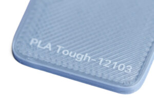 PLA Tough 12103 - KIT3D GmbH – 3D-Technologie & Konstruktion Close-up of a blue textured surface with the printed text 'PLA Tough-12103'.