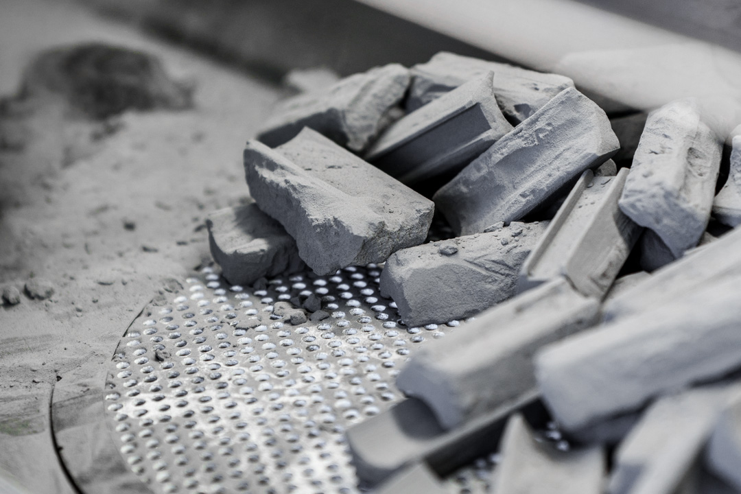 Entpulverte SLS-3D-Druckbauteile im Pulverbett während der Nachbearbeitung